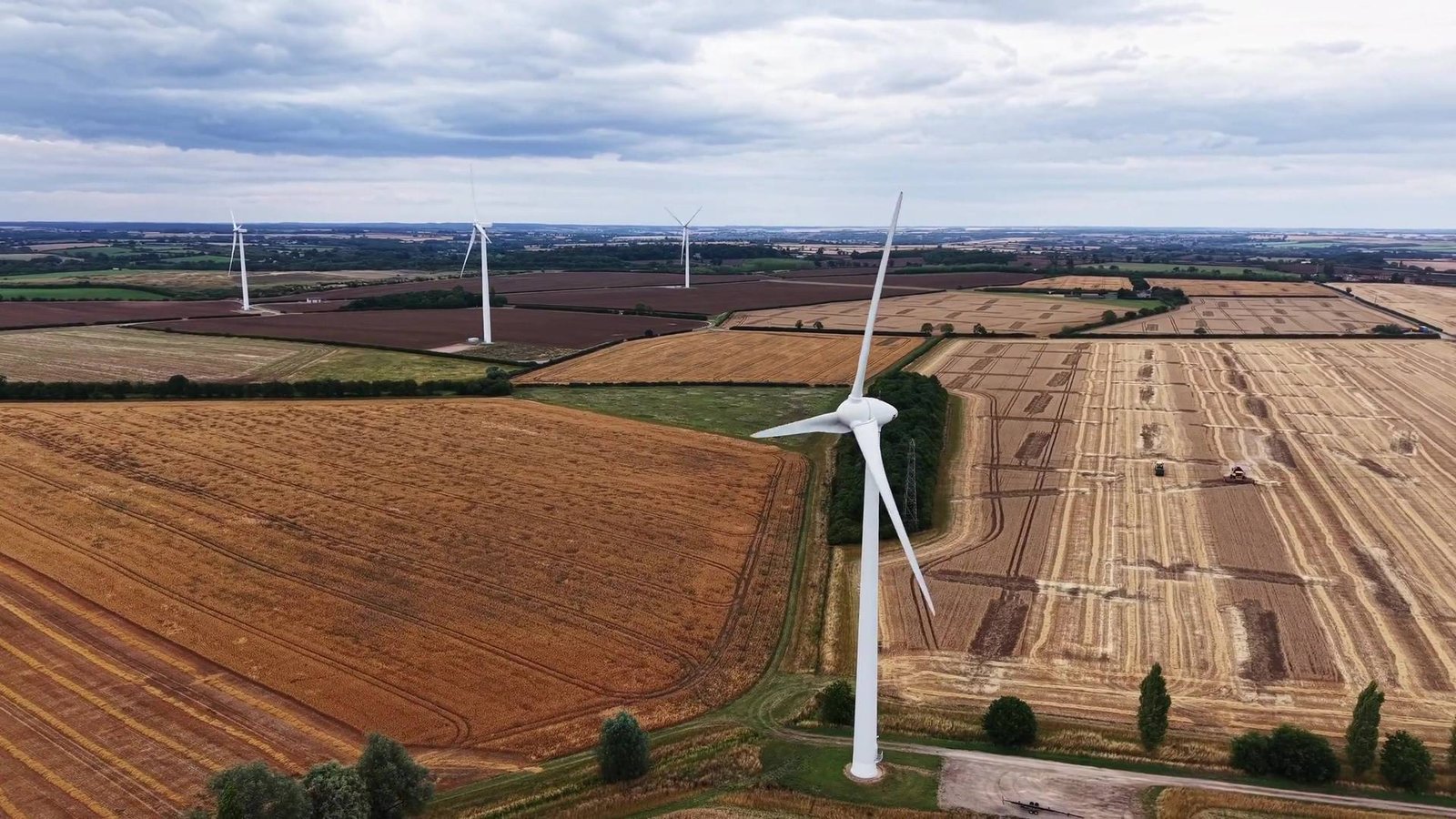 Aerial view of a wind turbine above farmland